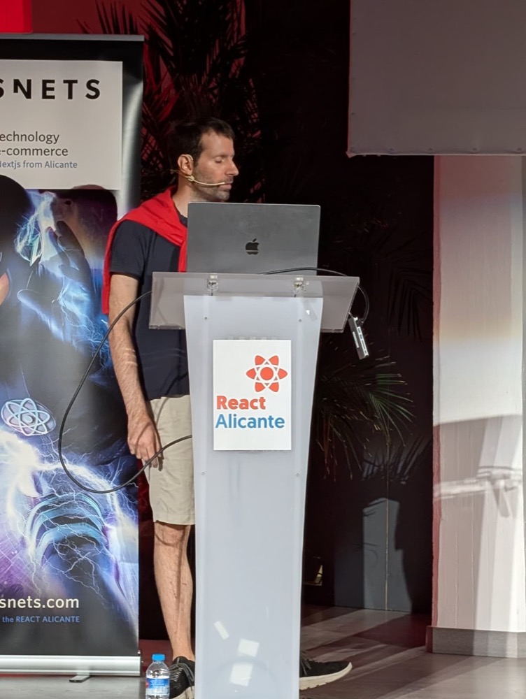 At the React Alicante lectern, 2026