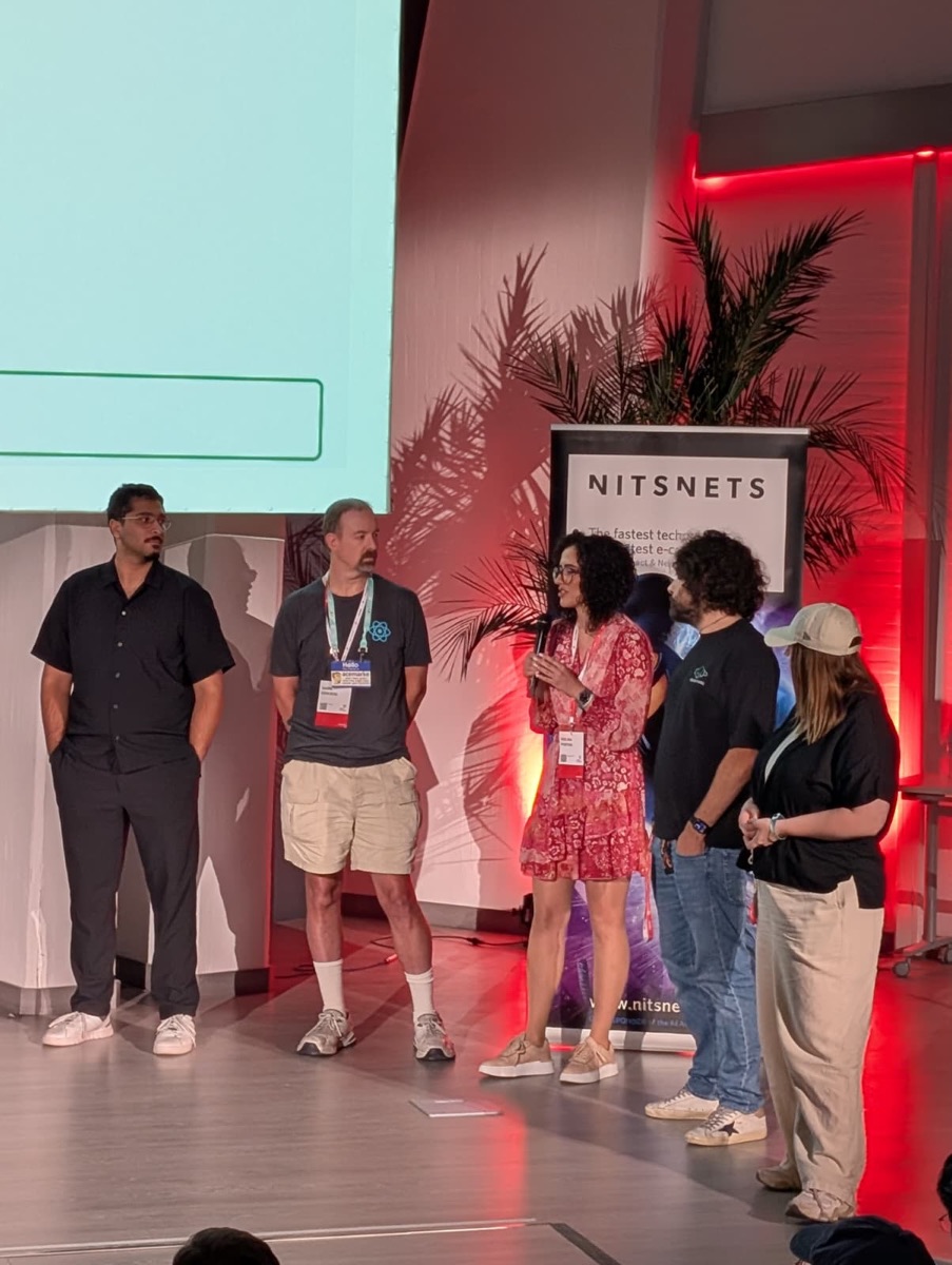 Speakers on stage during a panel at React Alicante 2026