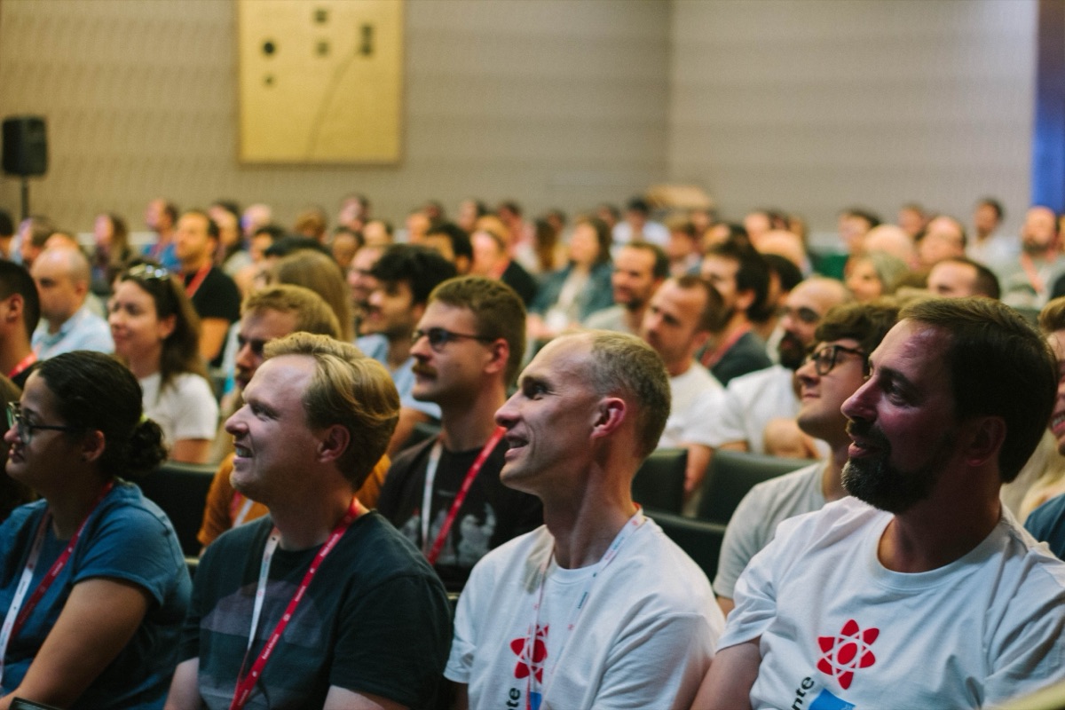 Attendees laughing during a talk at React Alicante 2019