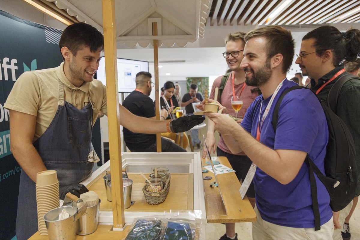 Attendees chatting at the coffee stand at React Alicante 2022