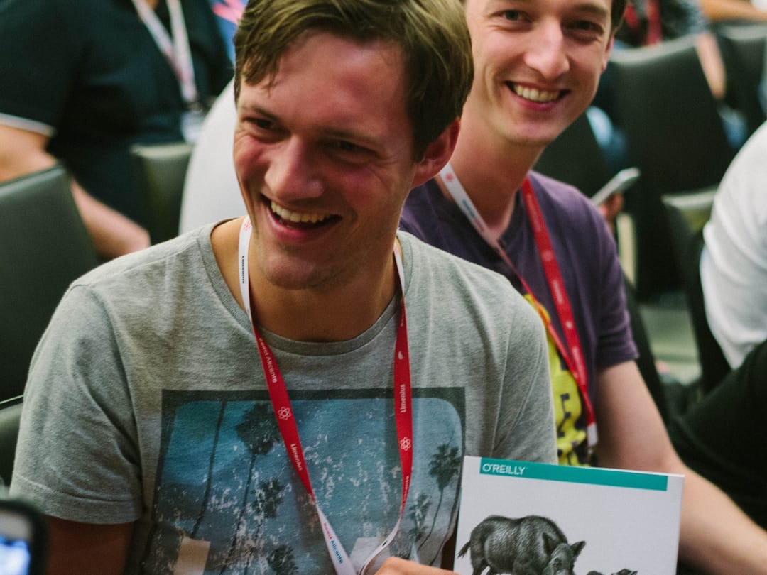 An attendee laughing with his new O’Reilly book, 2023